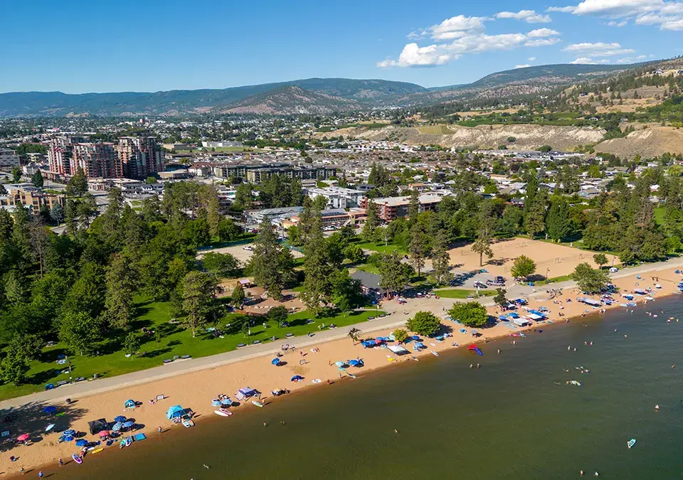 Panoramic hillside and lake view beside modern homes under a clear sky
