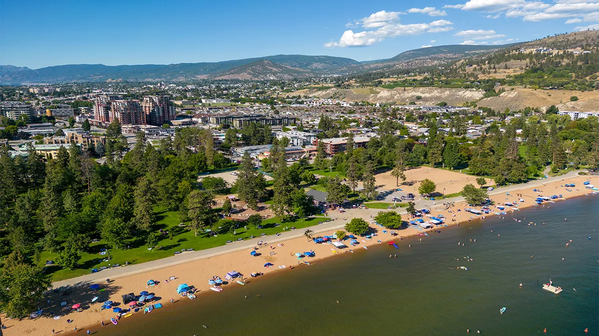 Panoramic hillside and lake view beside modern homes under a clear sky